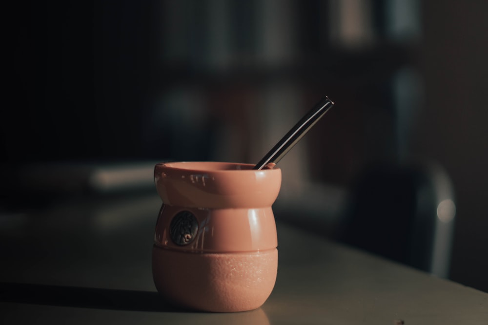 a cup with a straw in it sitting on a table