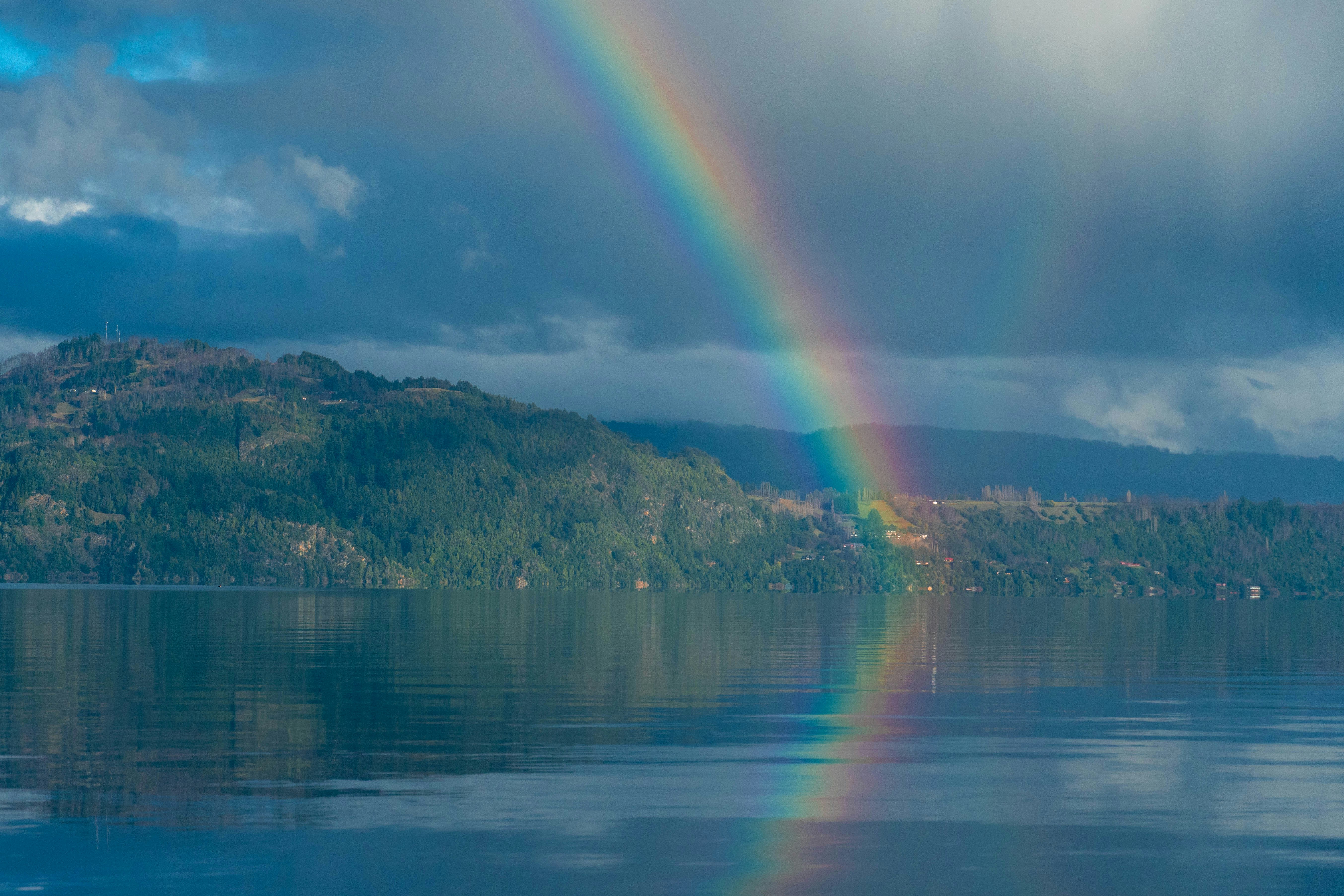 a rainbow in the sky over a body of water