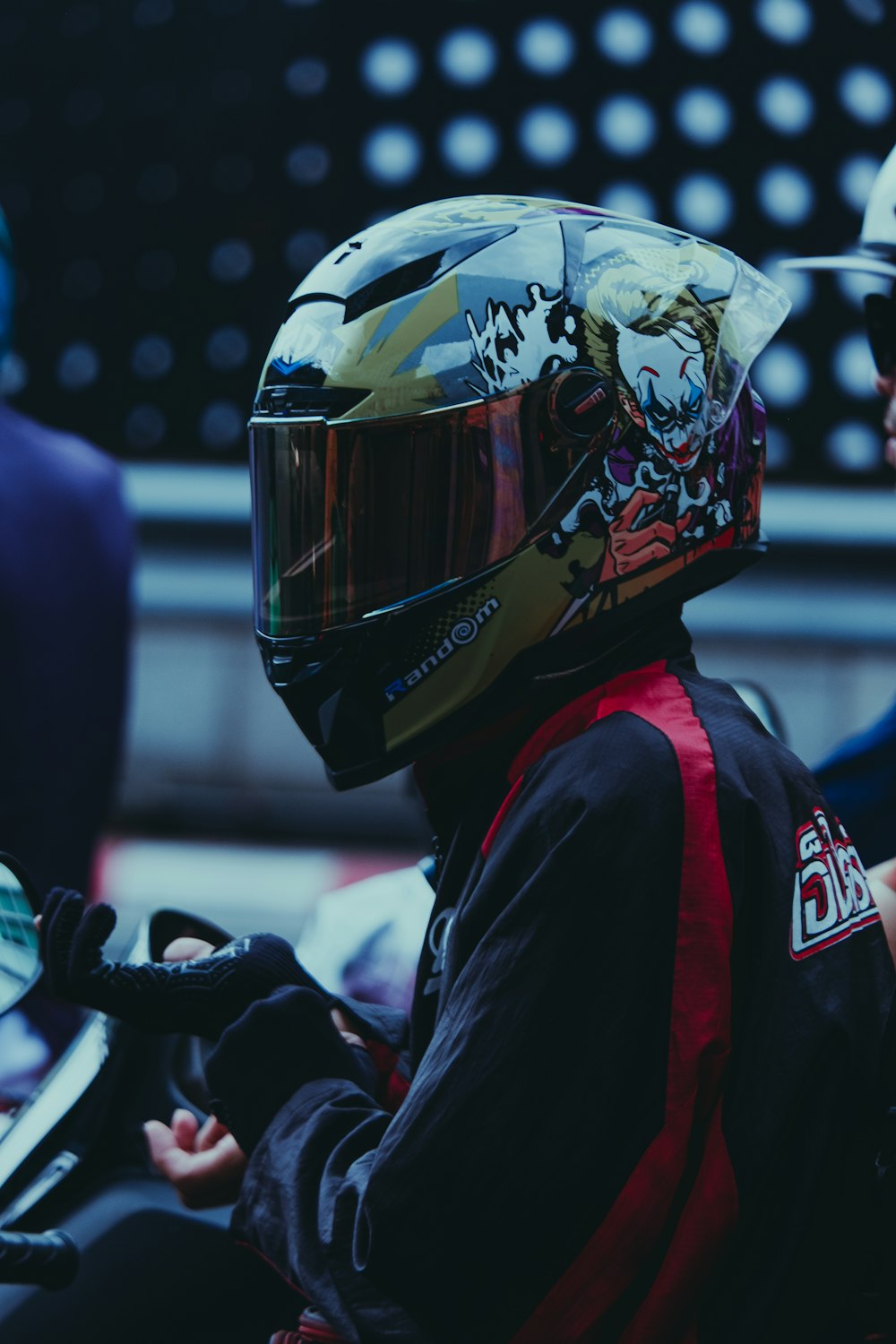 a person wearing a helmet sitting on a motorcycle