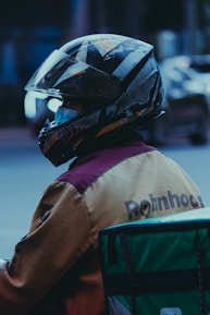 a person wearing a helmet sitting on a motorcycle