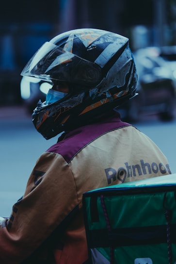 a person wearing a helmet sitting on a motorcycle