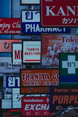 a bunch of signs that are on the side of a building