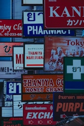 a bunch of signs that are on the side of a building