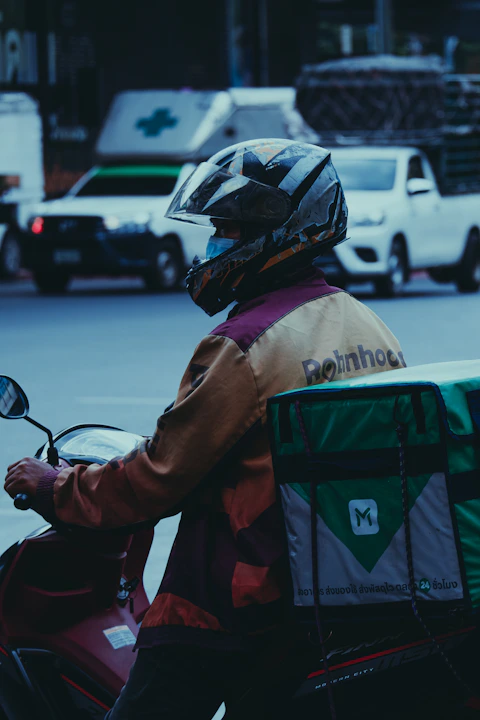 a man riding a motorcycle down a street