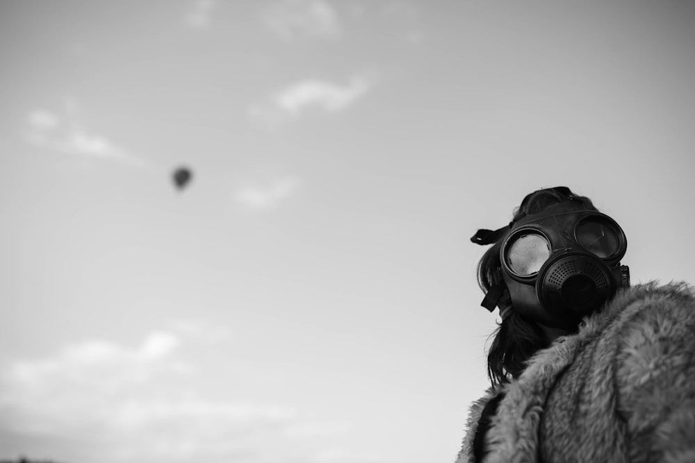 a person wearing a gas mask and a fur coat