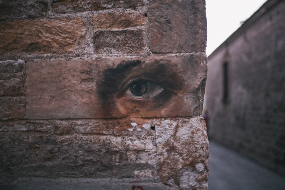 a brick wall with an eye painted on it