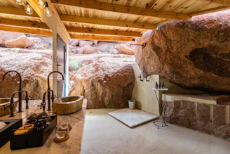 A refreshing cold plunge tub beside an outdoor shower with natural stone accents.