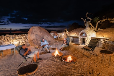 a group of people sitting around a fire pit