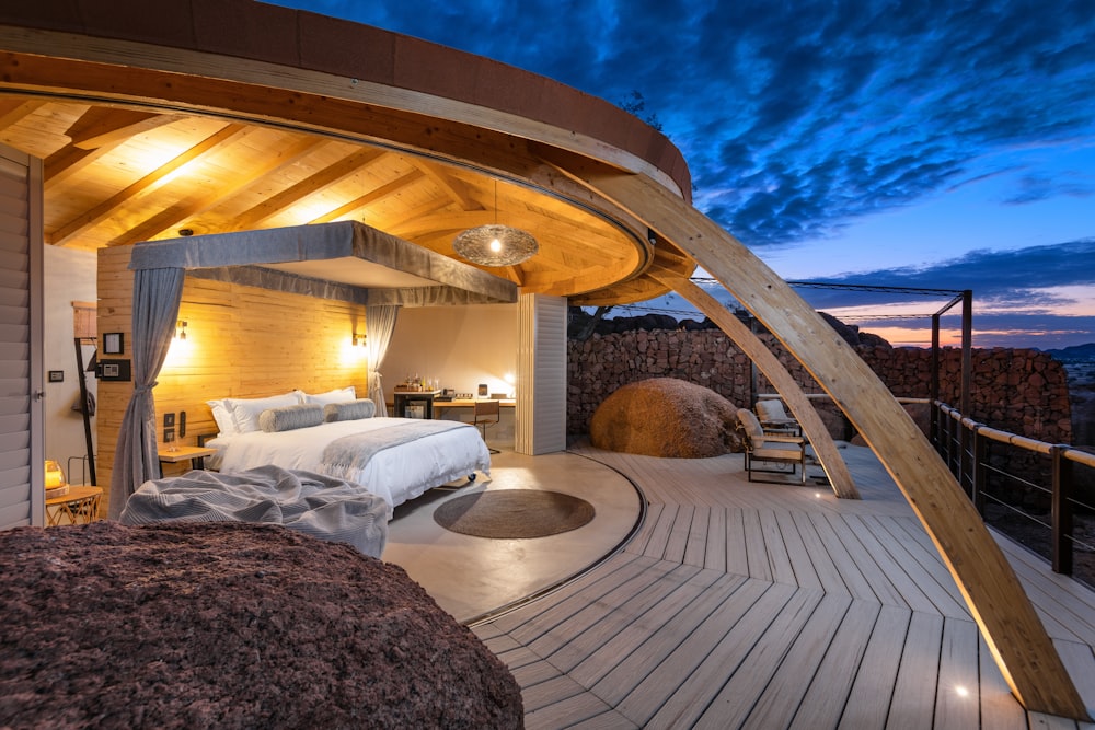 a bedroom with a wooden roof and a large bed