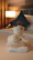 A smiling cleaner carefully arranging fresh towels in a cozy bedroom.