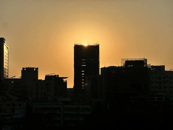 Sunset casting a blue and silver glow over a row of office towers in a bustling business district.