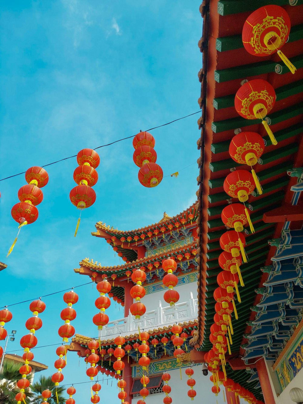 a group of red and yellow lanterns hanging from a roof