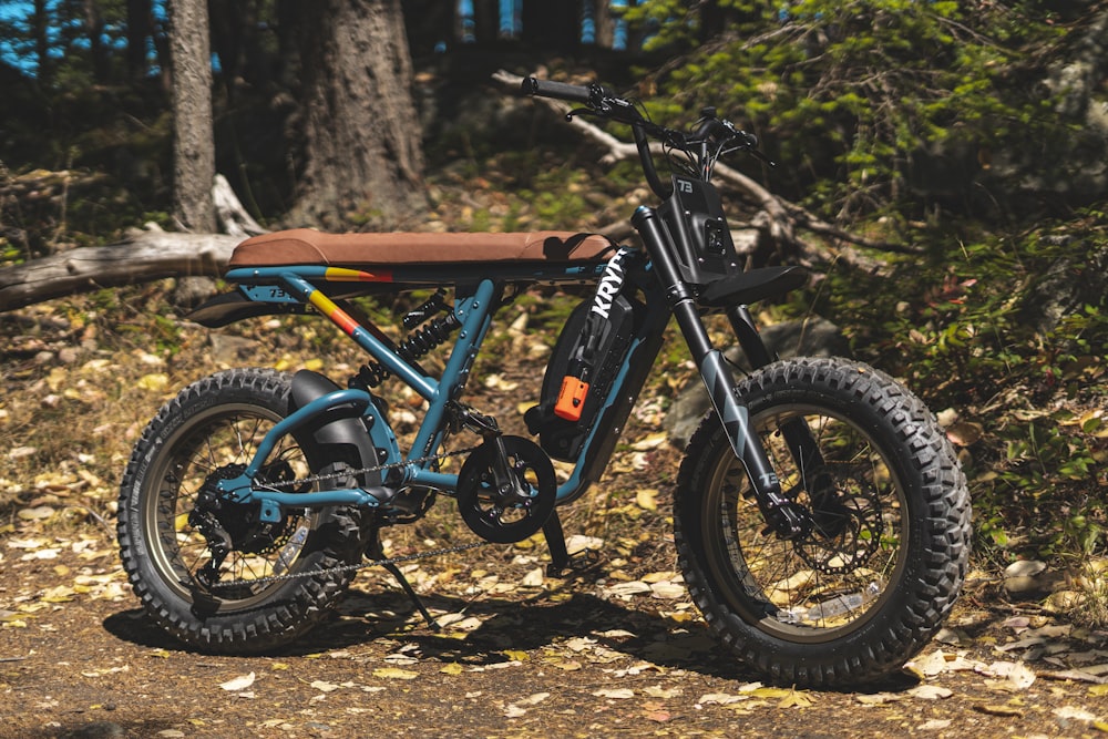 a blue dirt bike parked on a dirt road