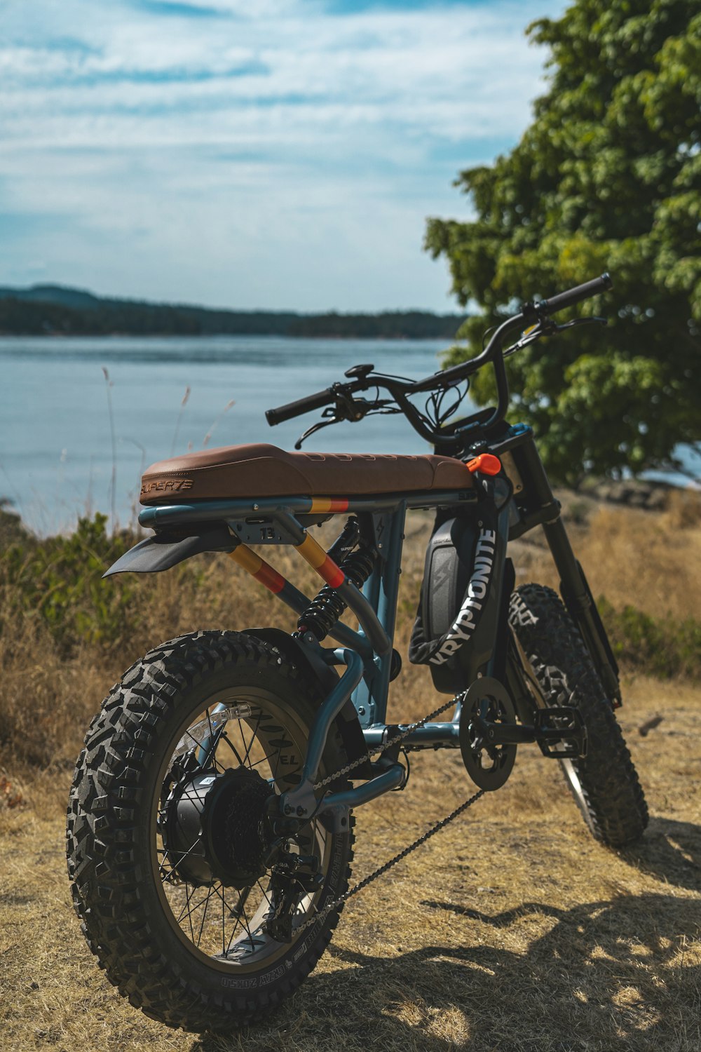 a dirt bike parked on top of a dry grass field