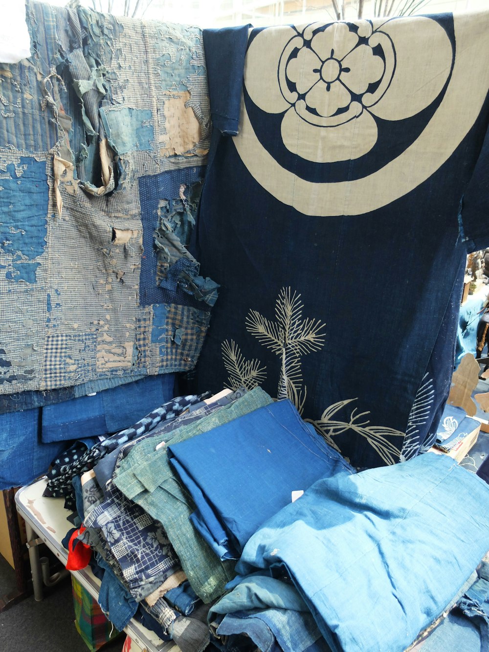 a pile of clothes sitting on top of a wooden table