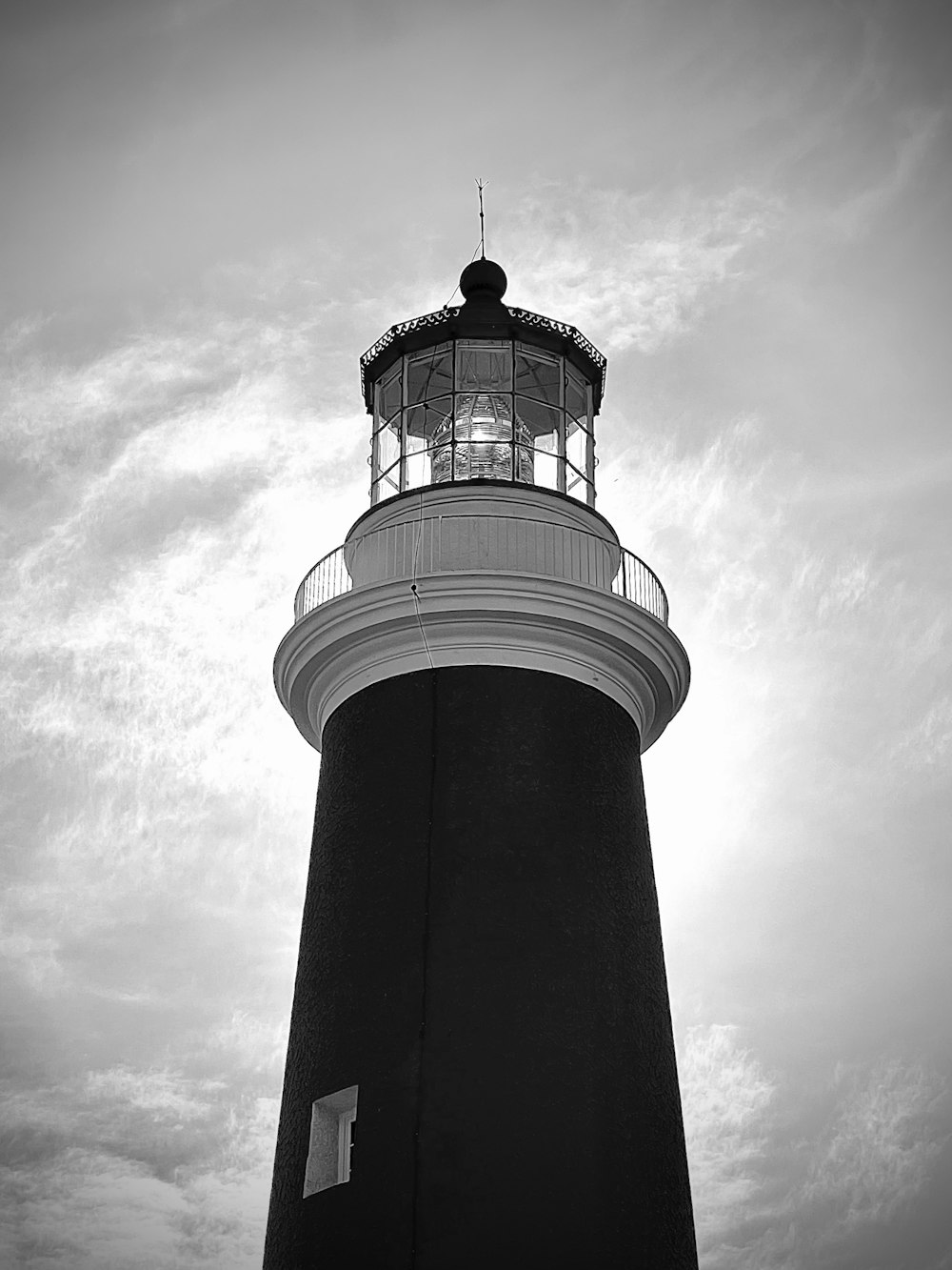 a black and white photo of a lighthouse