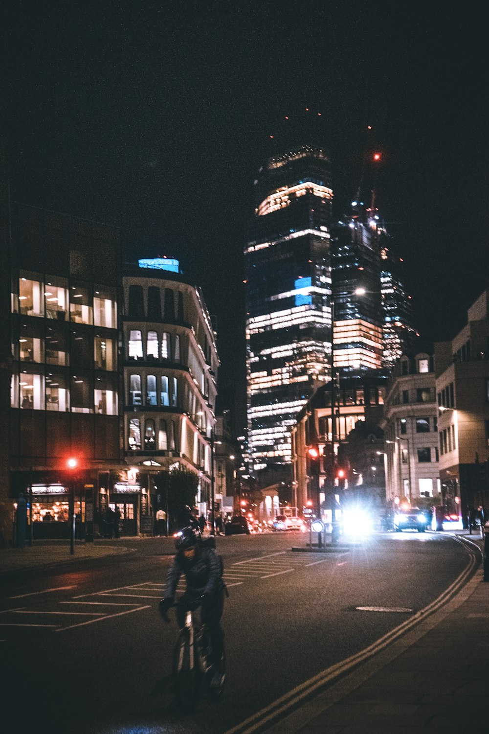 a man riding a motorcycle down a street at night