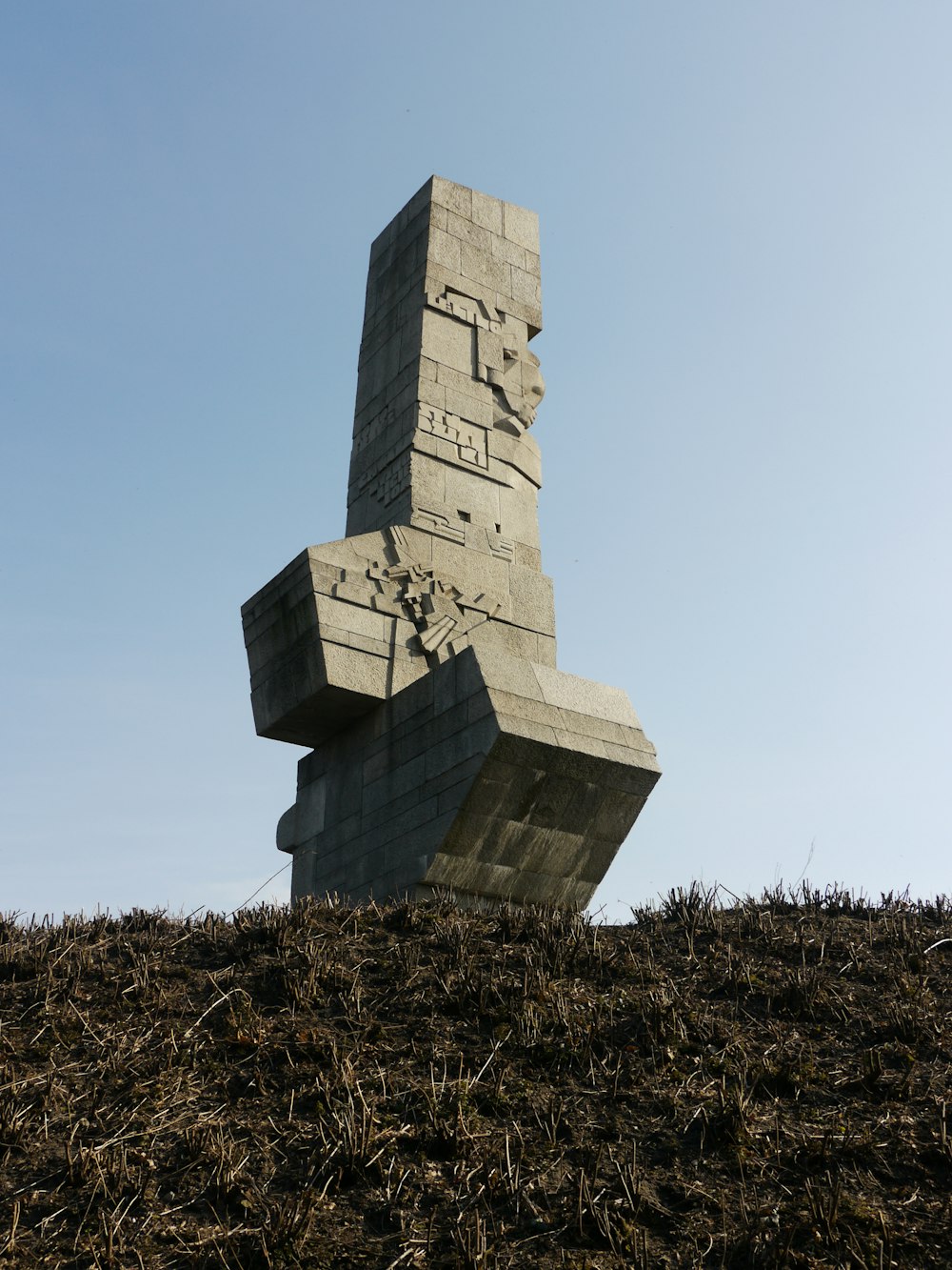 a sculpture made of blocks on top of a hill