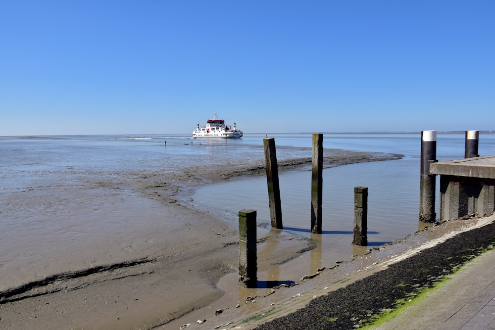 a boat is out on the water near a pier