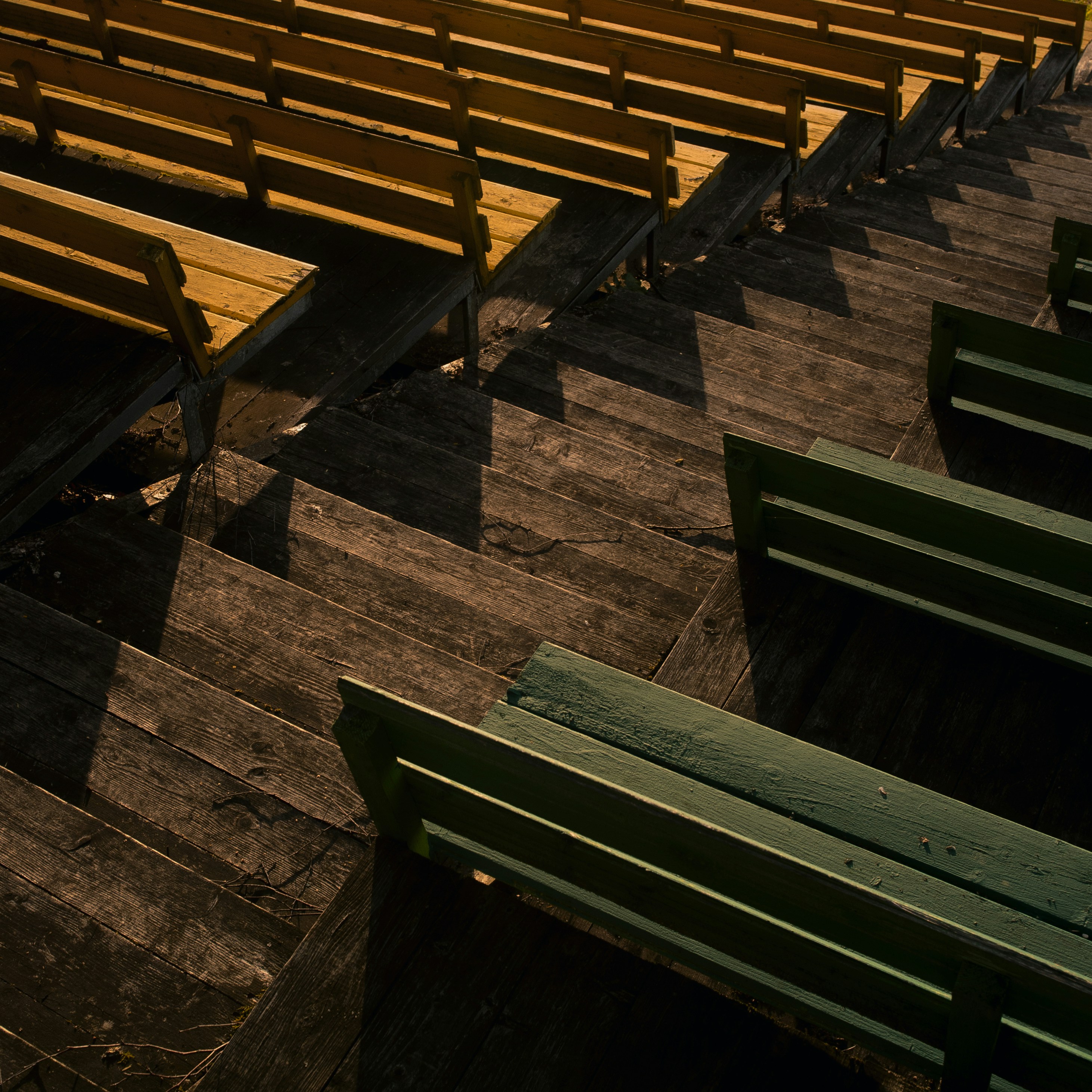 apostasy: a row of wooden benches sitting on top of a wooden floor