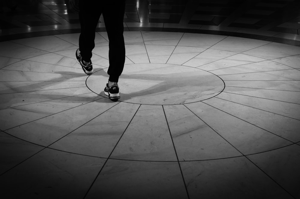a person walking on a circular tile floor