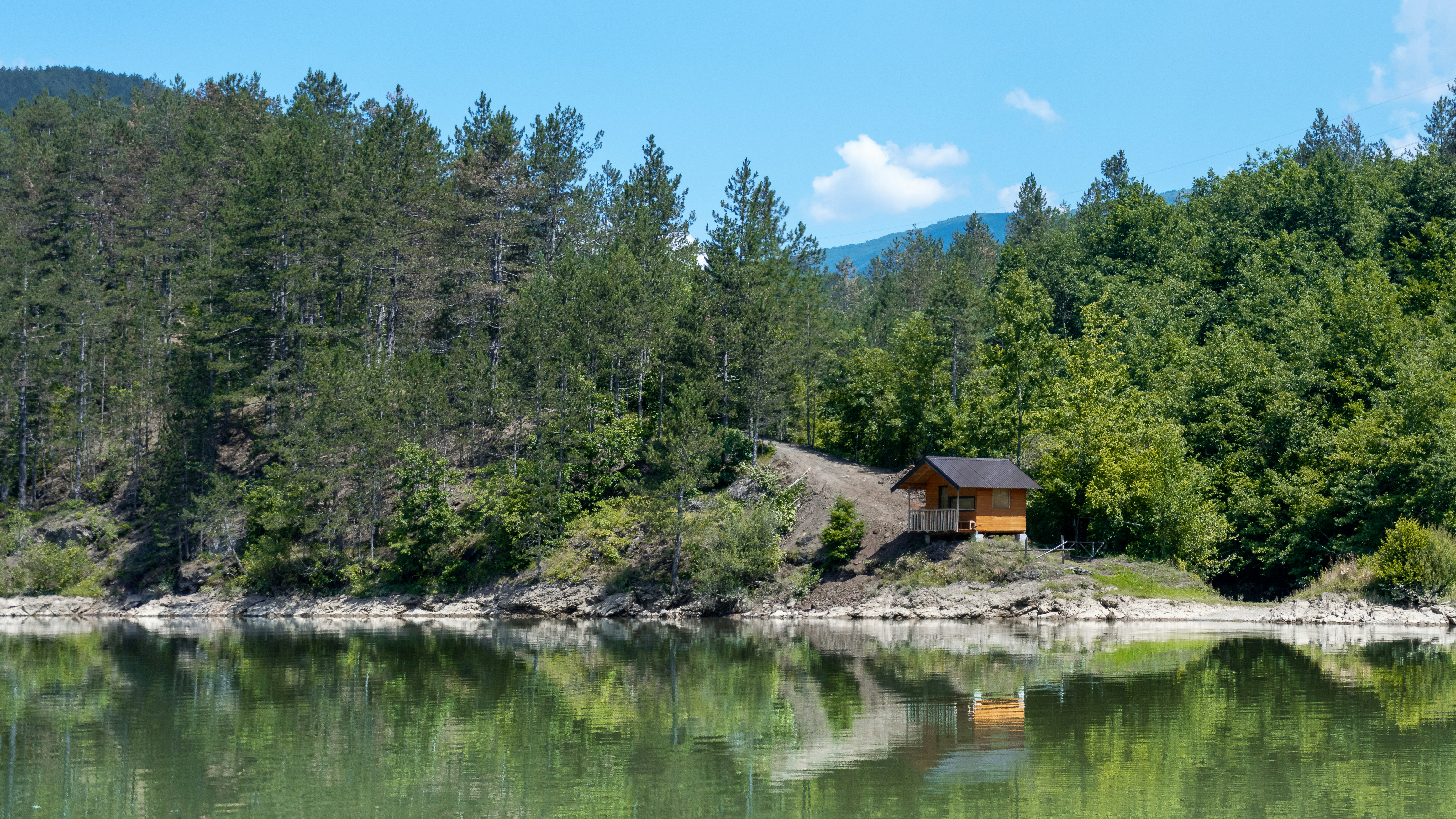 a small cabin on a small island in the middle of a lake
