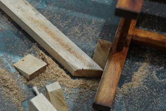  wood that is laying on the ground ready to become handcrafted furniture art
