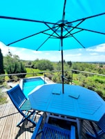 An expansive patio with elegant stonework and comfortable lounge furniture under a clear blue sky.