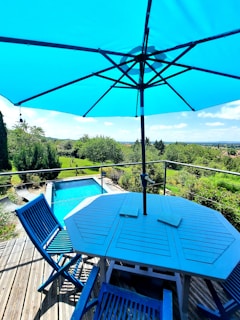 An expansive patio with elegant stonework and comfortable lounge furniture under a clear blue sky.