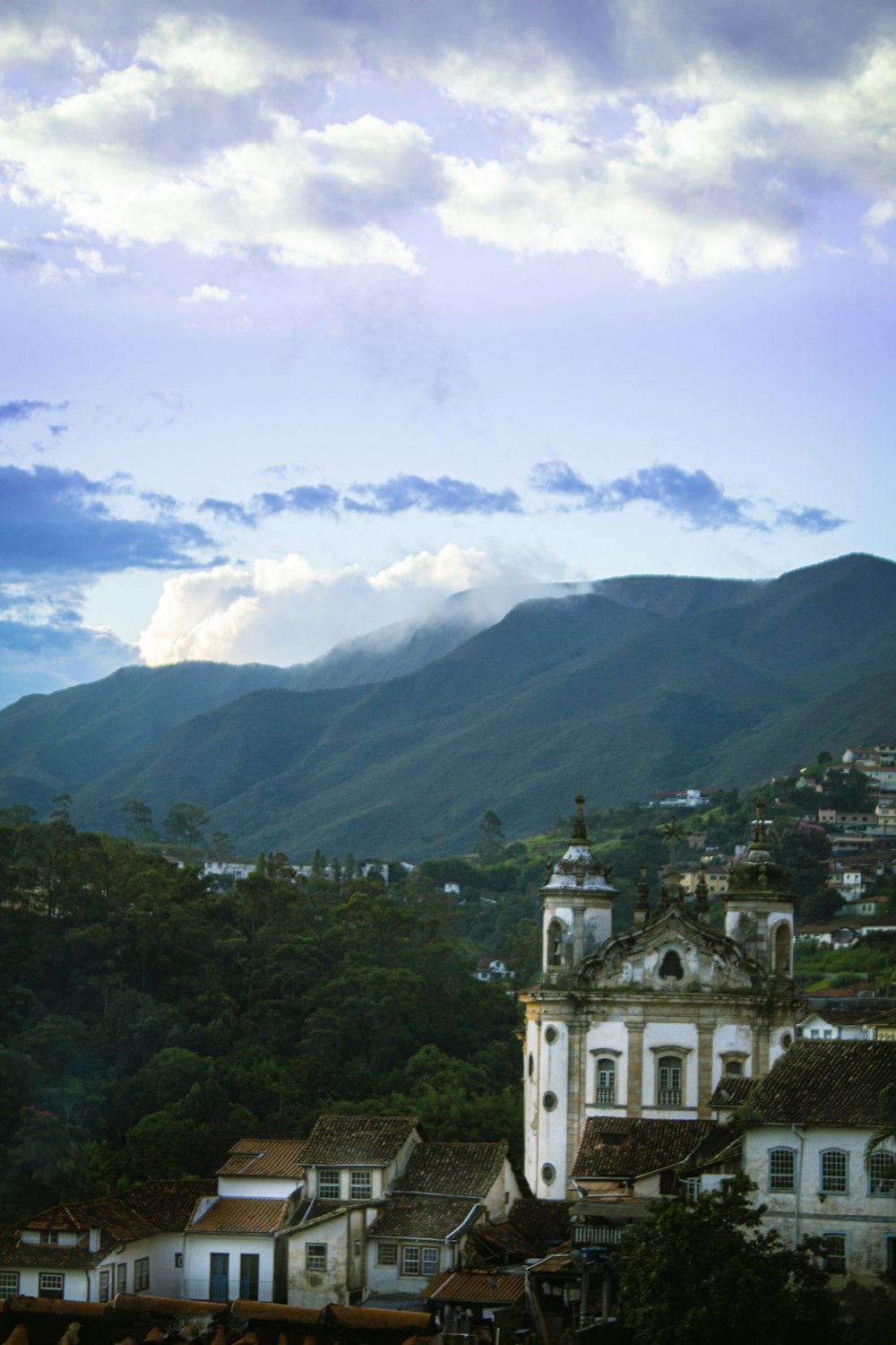 a view of a town with mountains in the background