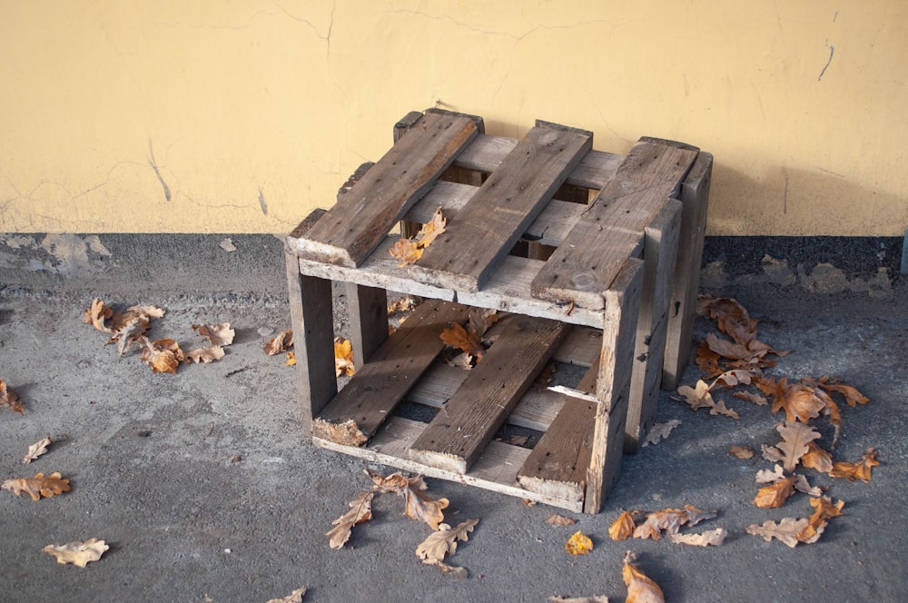 a pile of wooden pallets sitting on top of a cement floor