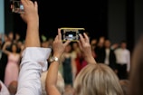 Photographer capturing candid moments during a theatrical performance.