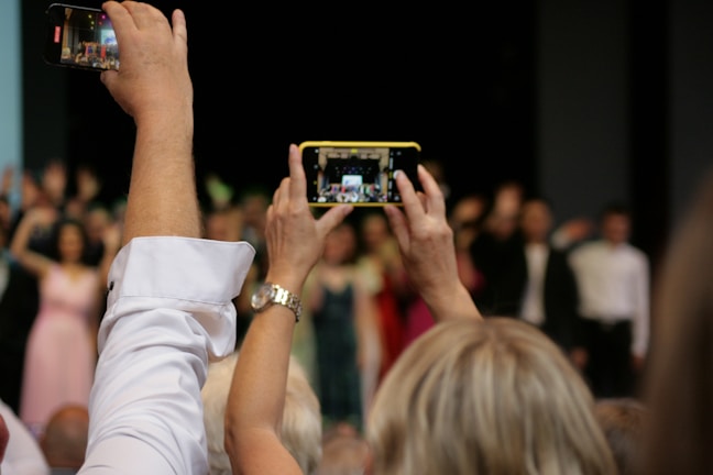 Photographer capturing candid moments during a theatrical performance.