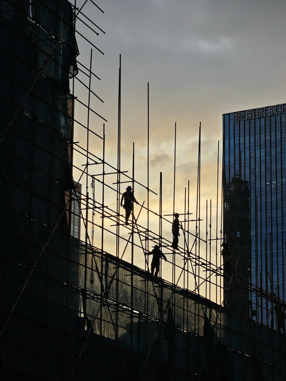 a group of men working on scaffolding in a city