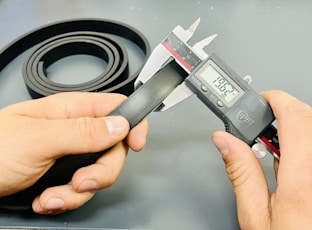 a person is holding VERNIER
