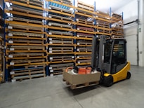 a forklift with a box on it in a warehouse