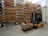 a forklift with a box on it in a warehouse