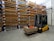 a forklift with a box on it in a warehouse