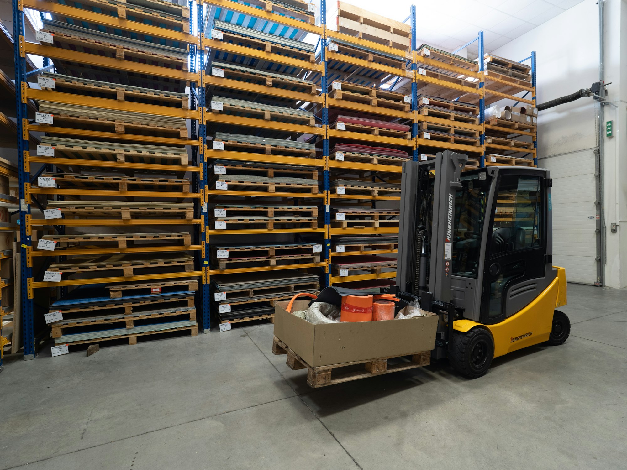 a forklift with a box on it in a warehouse