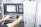 A person operates a control panel with various buttons, switches, and a digital screen displaying data. The background features a machine labeled AFINIS EXPRESS.