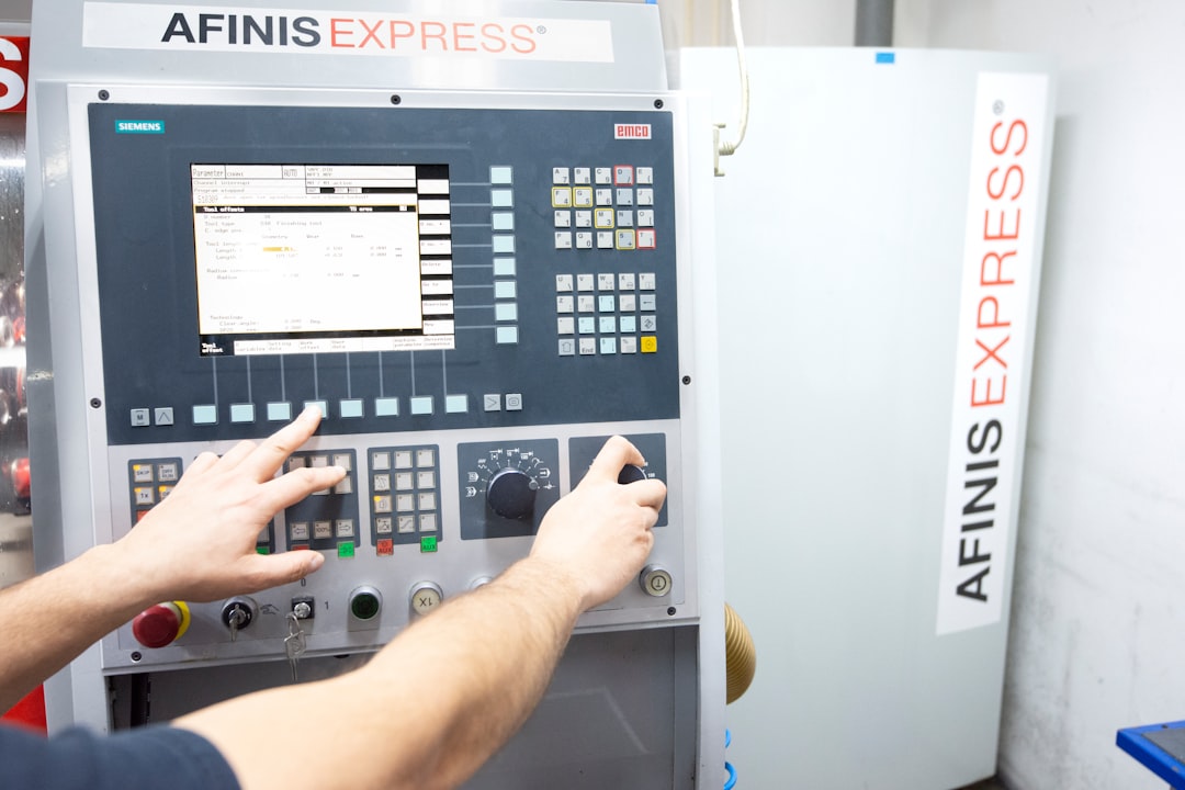 a man operating a machine in a factory, www.afinisgroup.sk