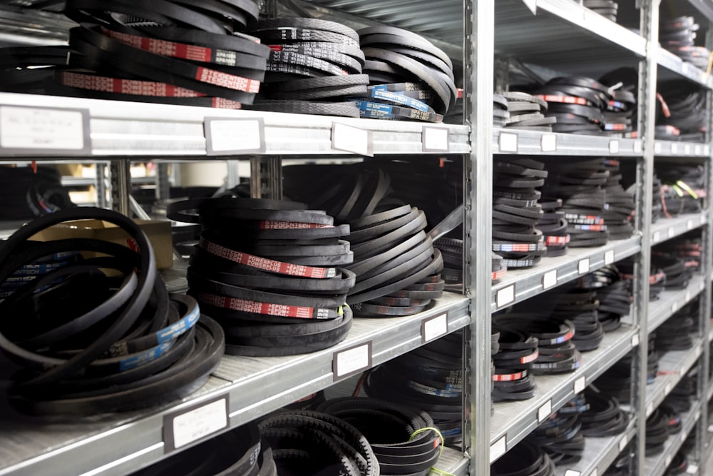 a bunch of tires are stacked on a shelf