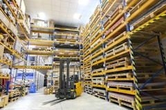 A wide-angle shot of a well-organized warehouse filled with neatly stacked general supplies and equipment.