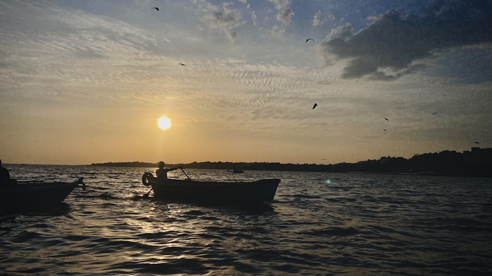 a couple of boats floating on top of a body of water