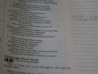 A thoughtful person reading ancient biblical texts with a modern world map in the background.