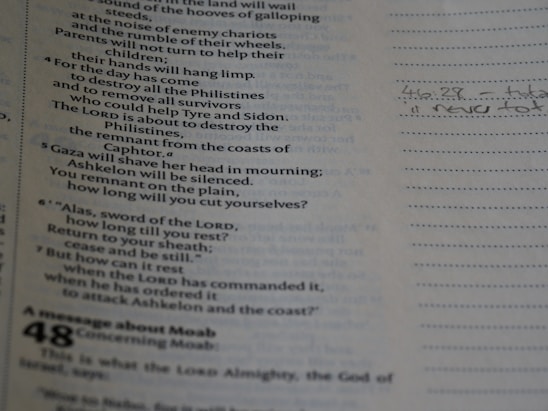 A thoughtful person reading ancient biblical texts with a modern world map in the background.