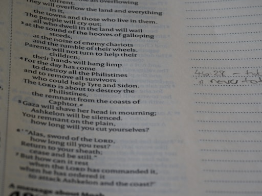 A page from a book is shown, with printed text on the left side. The text appears to be poetic or biblical in nature. To the right, there is a section with lined paper featuring handwritten notes, including a reference to a verse or page number.