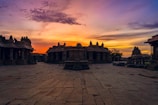 A vibrant sunset over the Ajanta Caves, with tourists admiring the ancient rock-cut art.