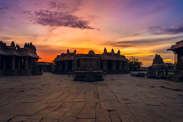 Sunset view of the ancient Khajuraho temple complex with intricate stone carvings.