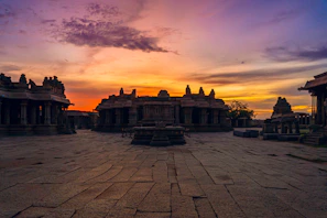 A vibrant sunrise over the Mahakaleshwar temple, casting golden light on ancient stone carvings.